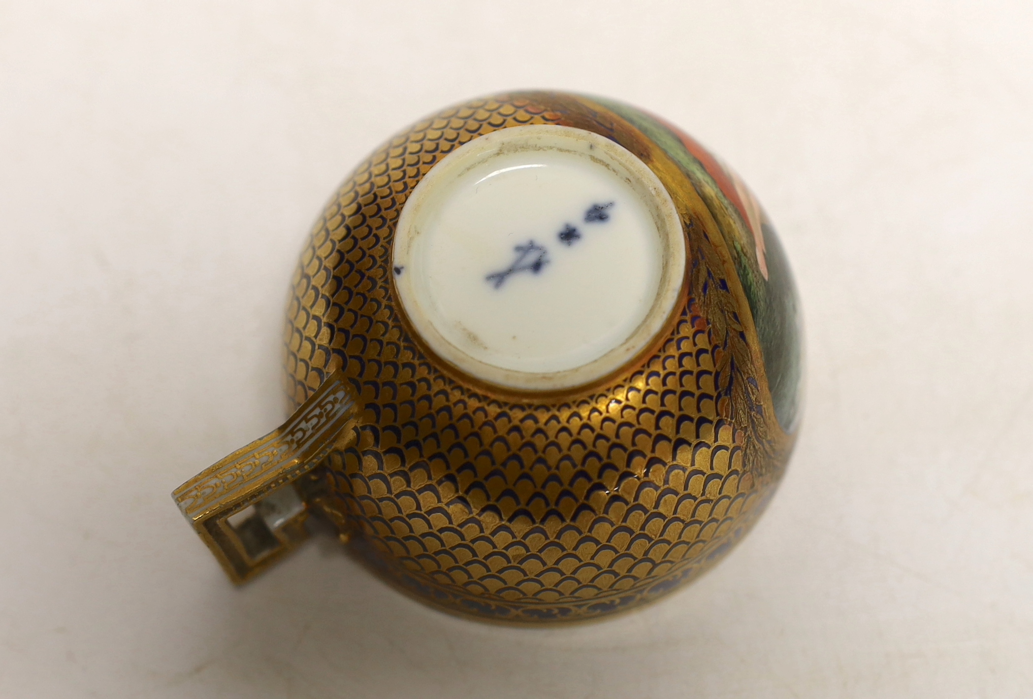 A Meissen Marcolini period cabinet cup, hand painted with figures beneath a tree and gilded interior, crossed sword mark to the base, 8.5cm wide